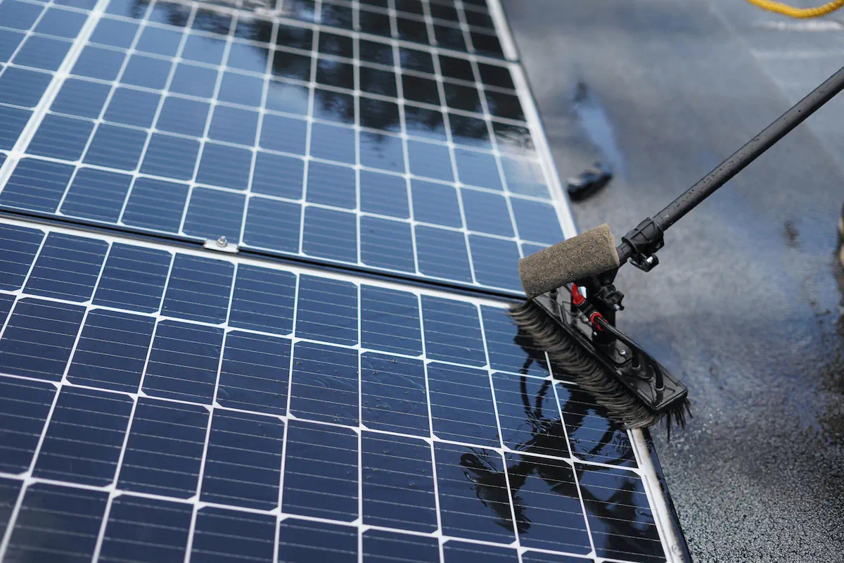 Solar panel cleaning using a soft brush and water for safe maintenance