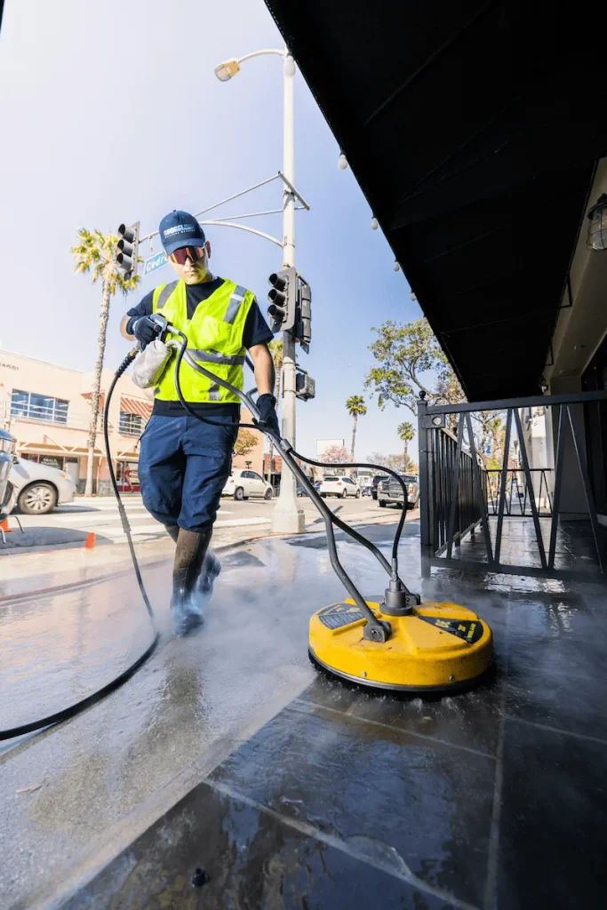 Commercial pressure washing of storefront sidewalk using professional surface cleaner