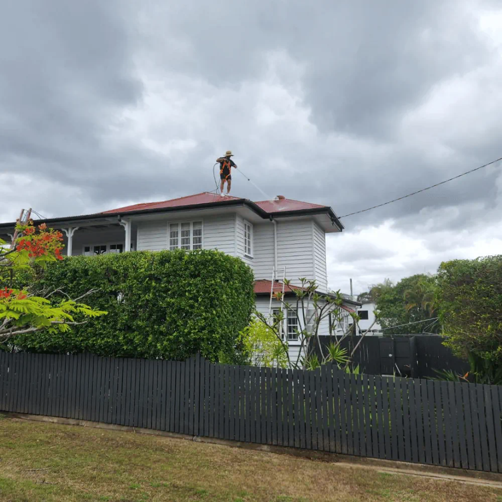 Residential pressure washing of roof to improve home exterior appearance